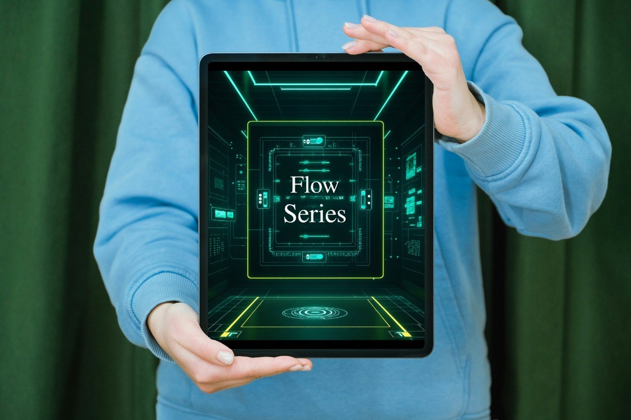 Person holding a tablet with a futuristic interface design on a green curtain background